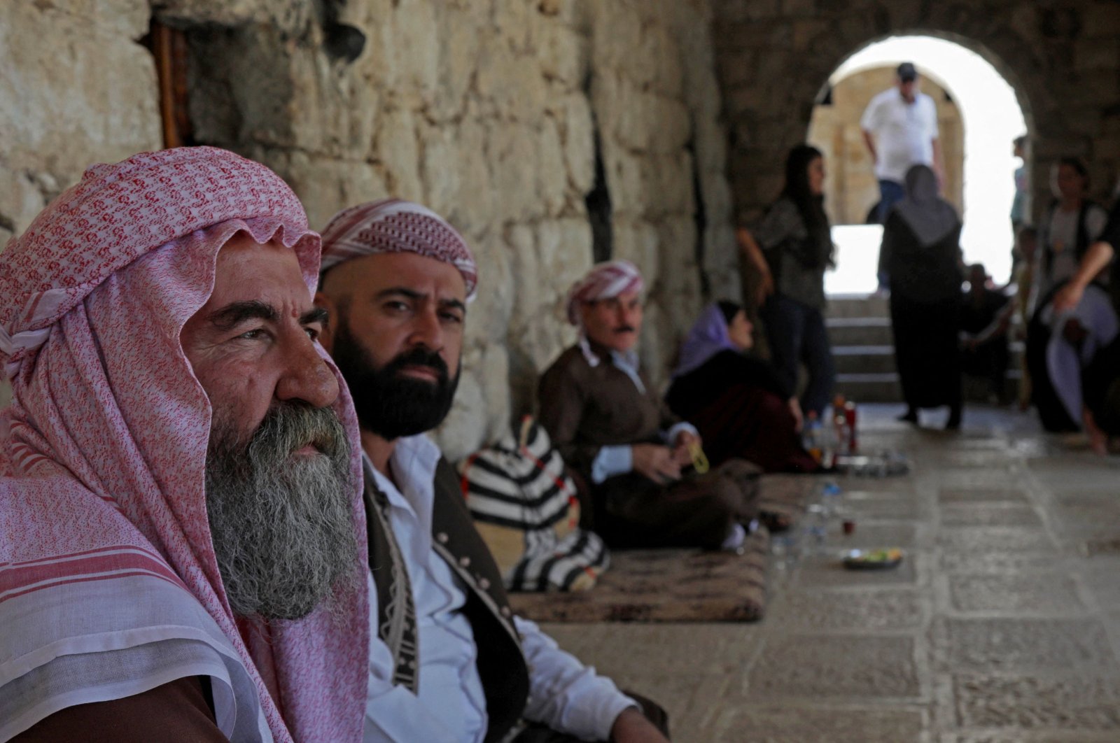 Iraqi Yazidis sit at the Temple of Lalish in a valley near Dohuk, Northern Iraq, Aug. 2, 2023. (AFP Photo)