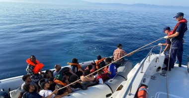 The Turkish coast guard helps a group of irregular migrants intercepted at sea, in Izmir, western Türkiye, Aug. 5, 2023. (DHA Photo)
