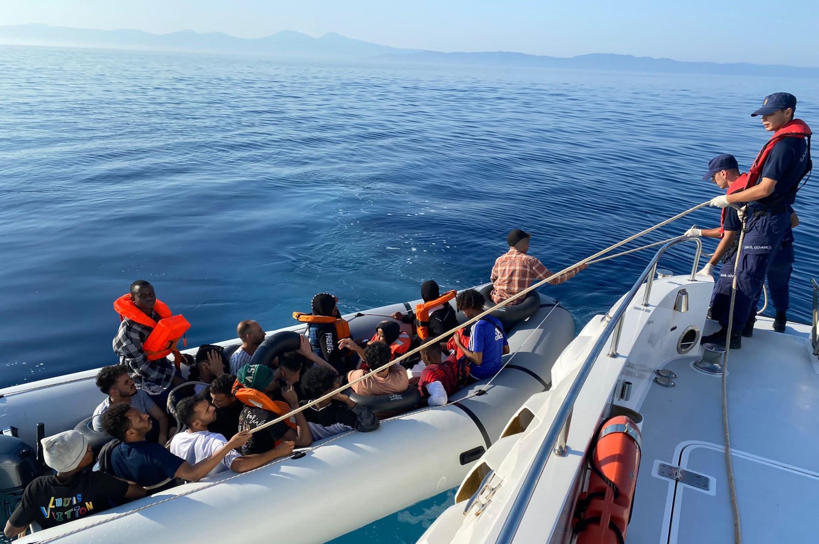 The Turkish coast guard helps a group of irregular migrants intercepted at sea, in Izmir, western Türkiye, Aug. 5, 2023. (DHA Photo)