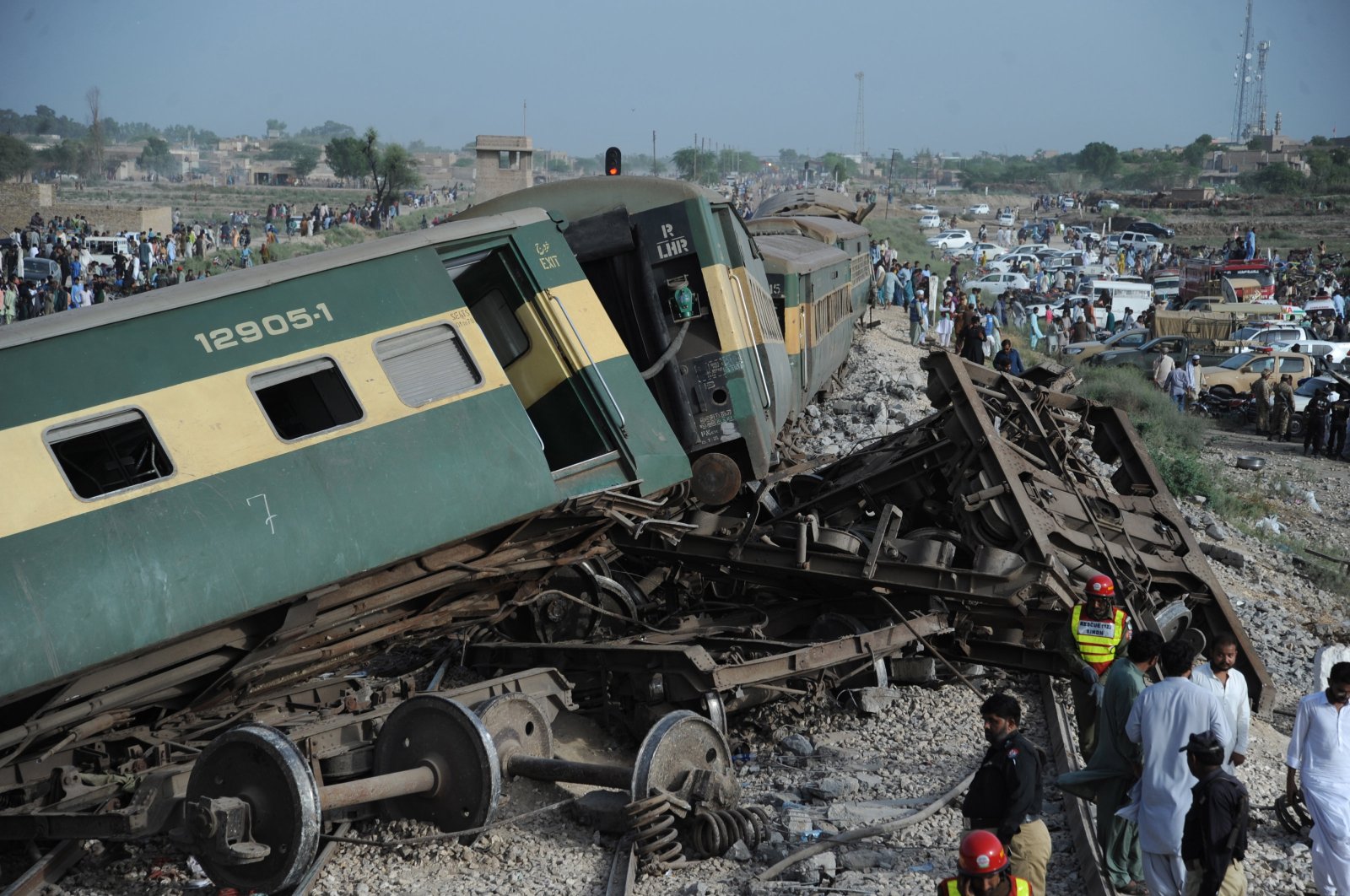 Pakistani security and rescue officials inspect the derailed carriages of a passenger train in Sanghar, Nawabshah, Pakistan, Aug. 6, 2023. (EPA Photo)