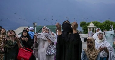 Kashmiri women raise their hands and pray during special prayers to observe the Martyr Day of the second Muslim Caliph Omar bin al-Khattab, in Srinagar, Indian controlled Kashmir, July 16, 2023. (AP Photo)