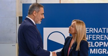 Hakan Fidan shakes hands with Italian Prime Minister Giorgia Meloni, as he arrives for a migration summit, in Rome, Italy, July 23, 2023. (AA Photo)