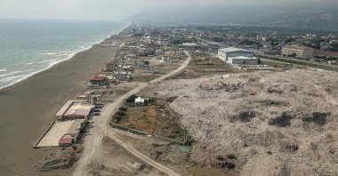 An aerial view of excavators working in a landfill next to a beach in Samandağ, in the south of Hatay province, which was devastated by the Feb. 6 earthquakes, southeastern Türkiye, July 9, 2023. (AFP Photo)