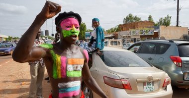 A supporter of the military junta with flags of Niger and Russia painted on his body attends a rally in Niamey, Niger, Aug. 6, 2023. (EPA Photo)