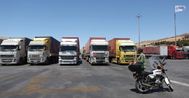 A convoy of trucks carrying humanitarian aid is seen parked after crossing the Syrian Bab al-Hawa border crossing with Türkiye, July 10, 2023. (AFP File Photo)