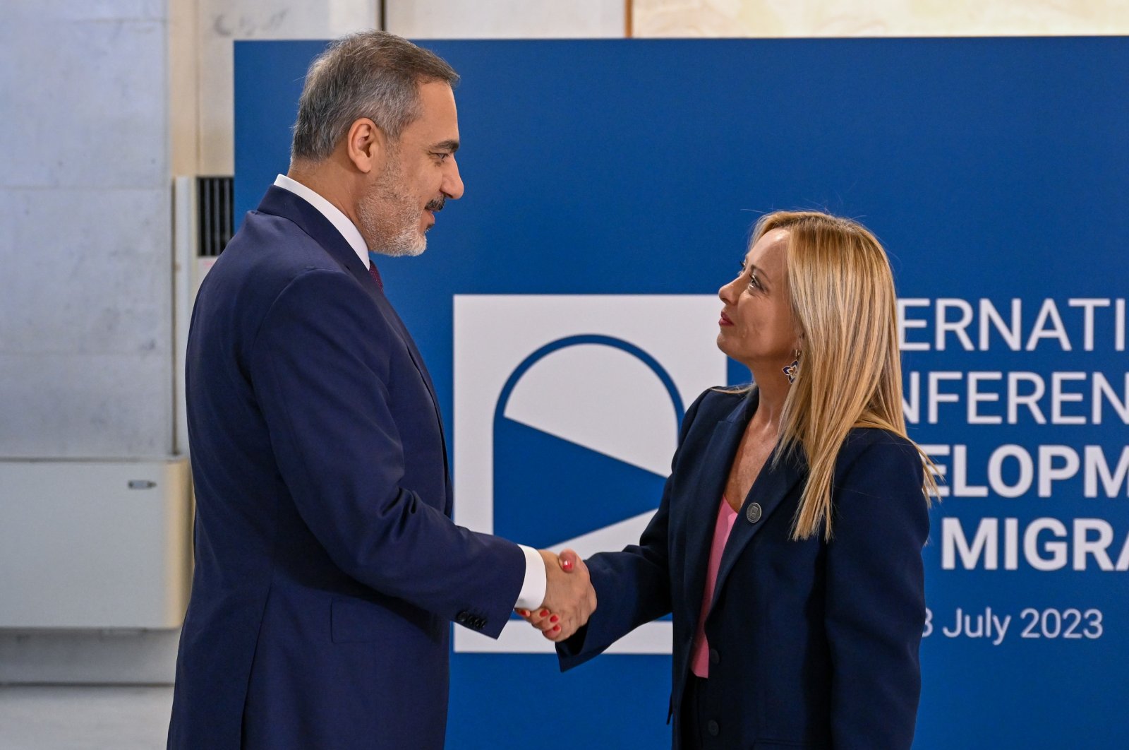 Hakan Fidan shakes hands with Italian Prime Minister Giorgia Meloni, as he arrives for a migration summit, in Rome, Italy, July 23, 2023. (AA Photo)