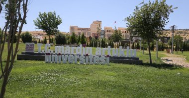 Front view of the sign reading Mardin Artuklu University, Mardin, southeastern Türkiye, Aug. 4, 2023. (AA Photo)