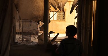 A youth inspects the remains of a house demolished by Israeli soldiers at the Askar refugee camp for Palestinian refugees east of Nablus in the occupied West Bank, Palestine, Aug. 8, 2023. (AFP Photo)