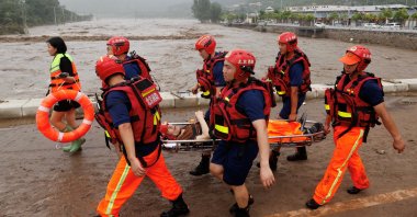 Rescue workers evacuate an elderly resident from a flood-affected village in Beijing, China, Aug. 1, 2023. (Reuters Photo)
