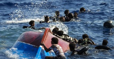 Migrants swim next to their overturned wooden boat during a rescue operation by Spanish NGO Open Arms south of the Italian Lampedusa island in the Mediterranean Sea, Thursday, Aug. 11, 2022. (AP File Photo)