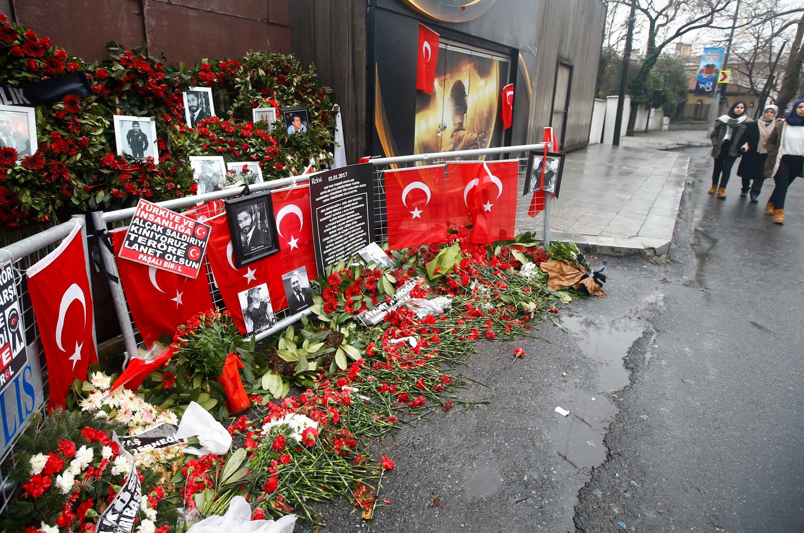 Flowers and pictures of the victims are placed near the entrance of Reina nightclub, attacked by a Daesh lone wolf terrorist, in Istanbul, Türkiye, Jan. 17, 2017. (Reuters Photo)