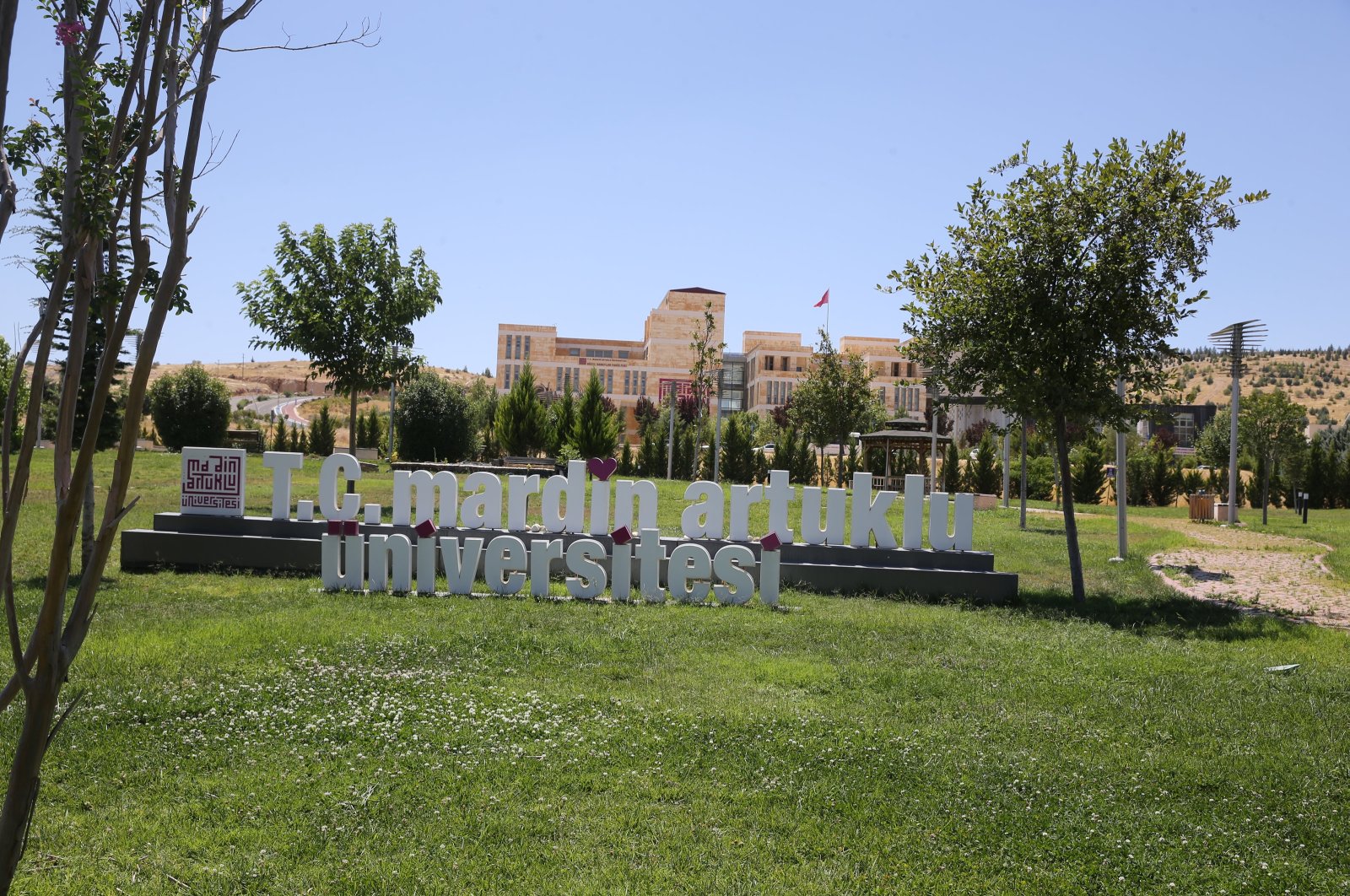 Front view of the sign reading Mardin Artuklu University, Mardin, southeastern Türkiye, Aug. 4, 2023. (AA Photo)