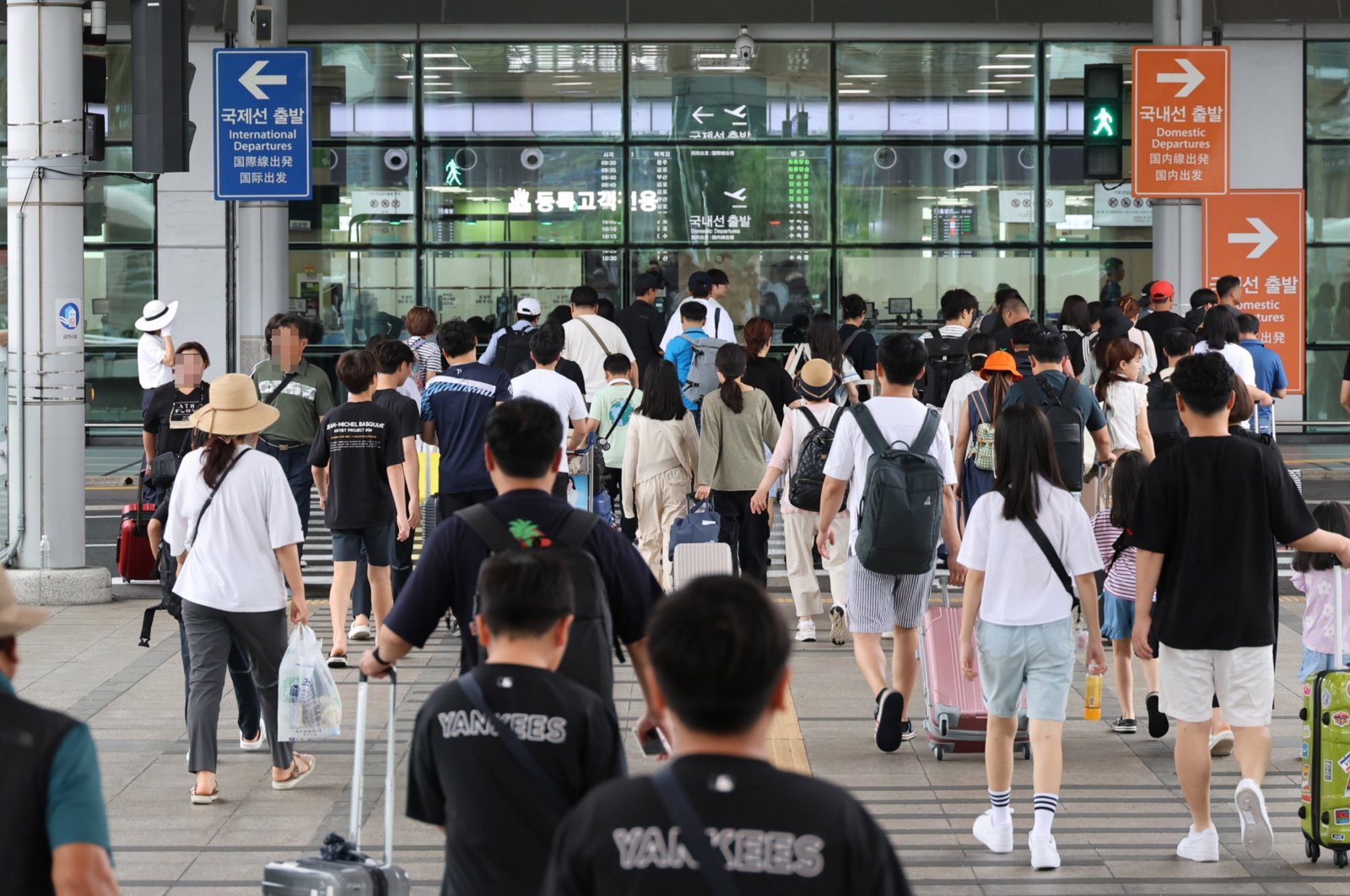 Tourists enter Jeju International Airport as they prepare to leave the island before Typhoon Khanun&#039;s arrival on the country&#039;s southern Jeju Island, South Korea, Aug. 9, 2023. (EPA Photo)