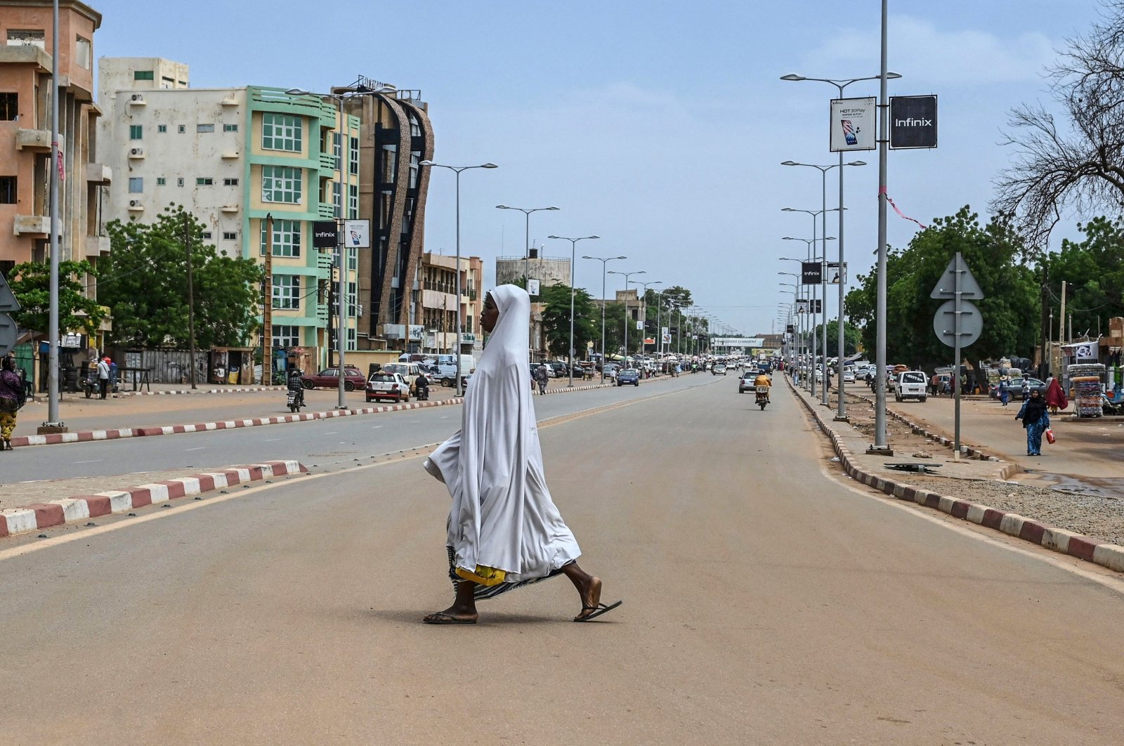 A woman walks across a road in Niamey, Niger, Aug. 8, 2023. (AFP Photo)