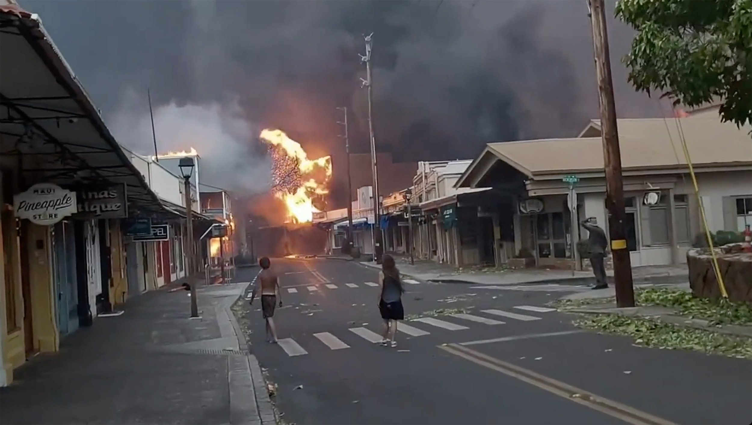 People watch as smoke and flames fill the air from raging wildfires on Front Street in Lahaina, Hawaii, U.S., Aug. 8, 2023. (AP Photo)