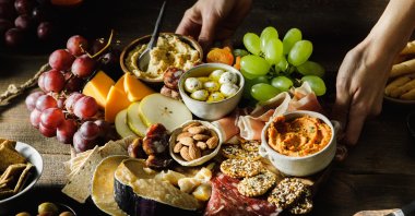 A cheese and meat platter with fruits. (Getty Images Photo)