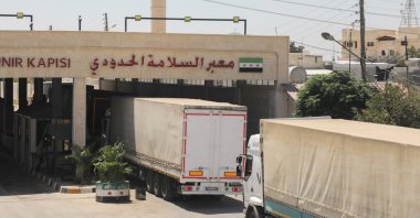 Trucks drive through the border crossing at Bab al-Salameh in Aleppo countryside, Syria, Aug. 9, 2023. (Reuters Photo)