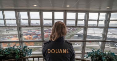 A Dutch customs police officer looks out over Rotterdam harbor, the Netherlands, Nov. 3, 2022. (AFP Photo)