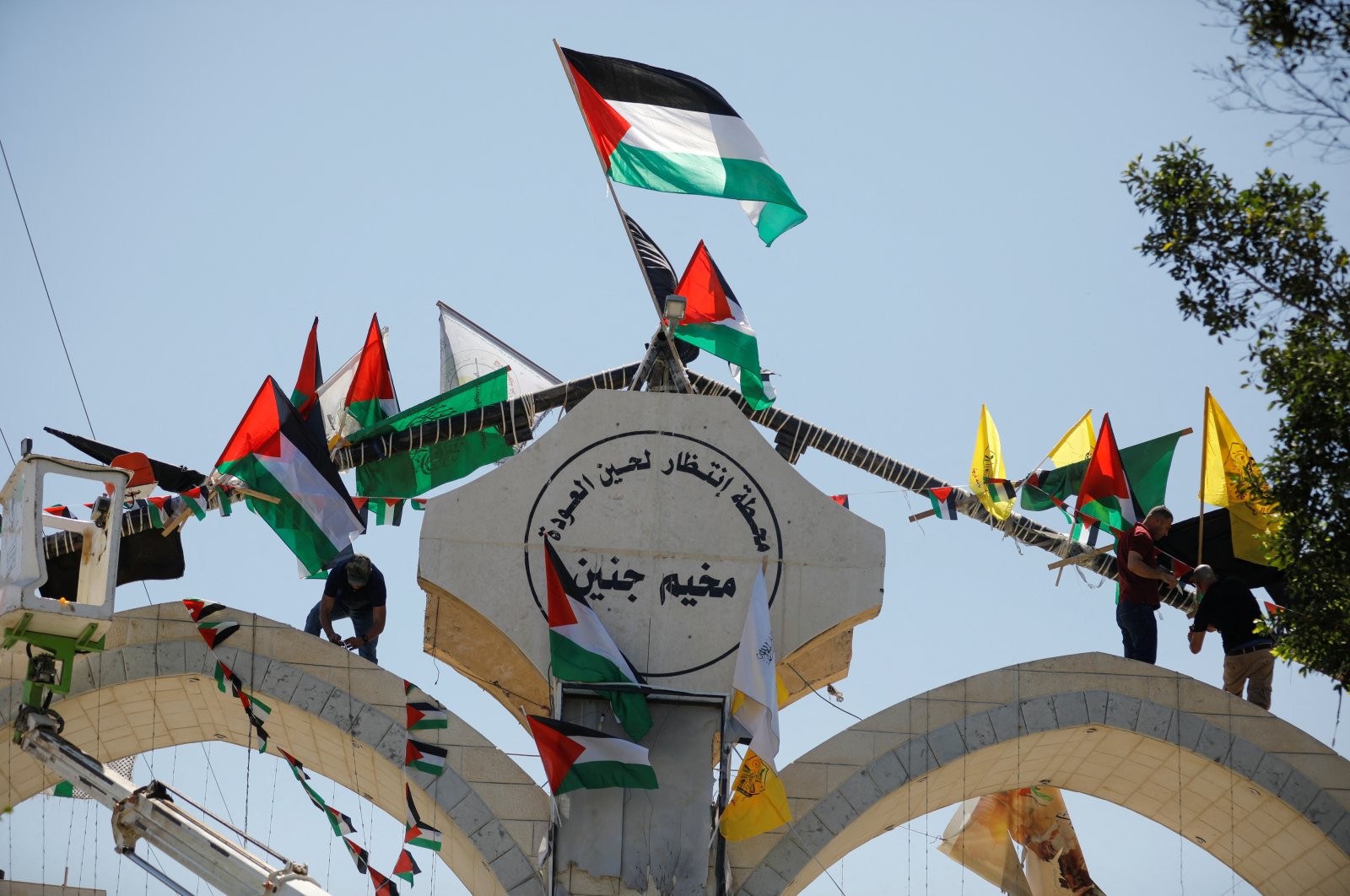 People hang Palestinian flags on the day Palestinian President Mahmoud Abbas visits Jenin following a recent Israeli raid, in the Israeli-occupied West Bank, Palestine, July 12, 2023. (Reuters Photo)