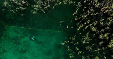 A diver searches for archaeological material in Lake Ohrid, southeastern Albania, July 27, 2023. (AFP Photo)