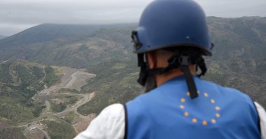 A European Union observer looks in the direction of a checkpoint at the entry of the Lachin corridor, in Karabakh, Azerbaijan, July 30, 2023. (AFP Photo) 