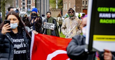 Demonstrators stage a protest against racism at a police station as they demand the dismissal of five police officers who expressed racist stances against immigrants in a WhatsApp group, in Rotterdam, Netherlands, March 28, 2021. (Reuters Photo)