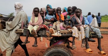 Sudanese refugee children ride a cart while crossing the border between Sudan and Chad, Adre, Chad, Aug. 4, 2023. (Reuters Photo)
