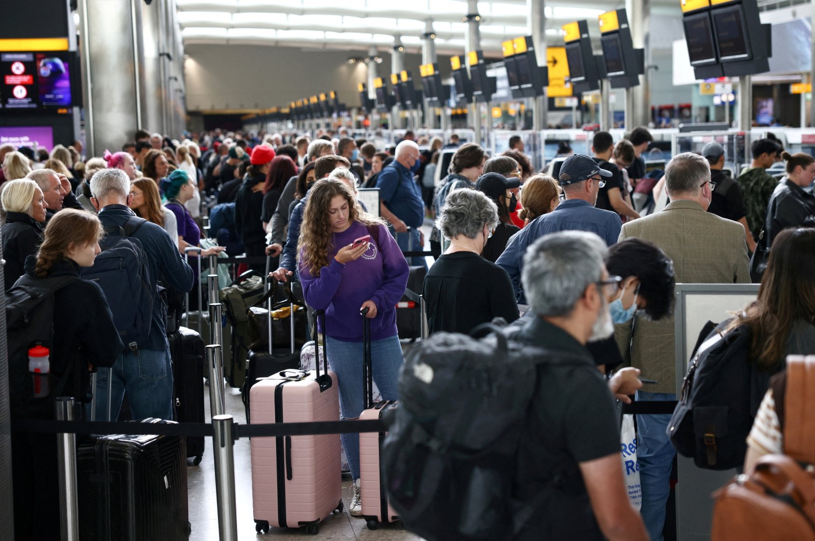 Passengers line up inside the departures terminal of Terminal 2 at Heathrow Airport in London, Britain, June 27, 2022. (Reuters Photo)