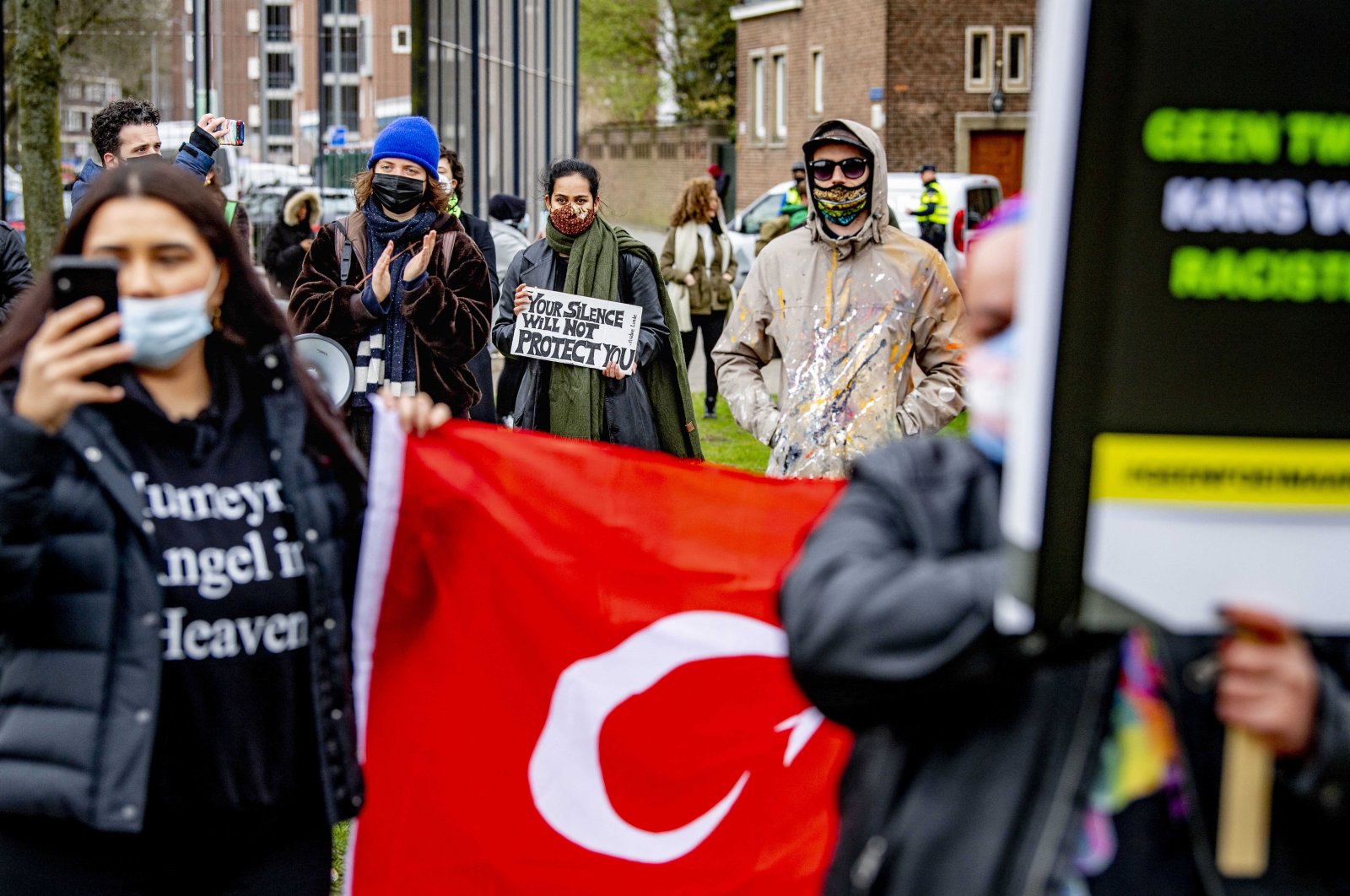 Demonstrators stage a protest against racism at a police station as they demand the dismissal of five police officers who expressed racist stances against immigrants in a WhatsApp group, in Rotterdam, Netherlands, March 28, 2021. (Reuters Photo)