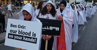 Activists march with placards denouncing violent crimes against Arab communities, Tel Aviv, Israel, Aug. 6, 2023. (AFP Photo)