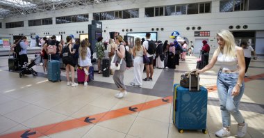 Tourists are seen at the airport in the Mediterranean tourism hot spot Antalya, southern Türkiye, Aug. 8, 2023. (AA Photo)