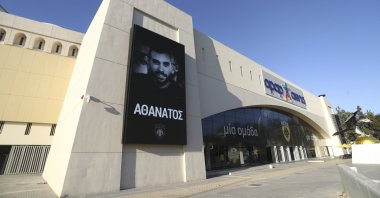 A banner depicting AEK Athens fan Michalis Katsouris outside AEK's Opap Arena, Athens, Greece, Aug. 11, 2023. (AP Photo)