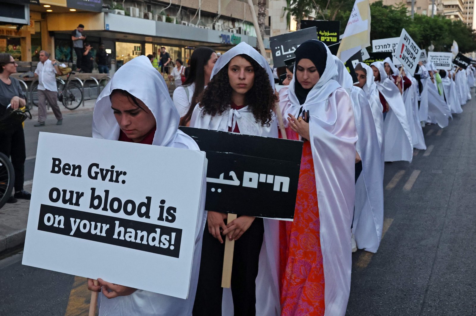 Activists march with placards denouncing violent crimes against Arab communities, Tel Aviv, Israel, Aug. 6, 2023. (AFP Photo)