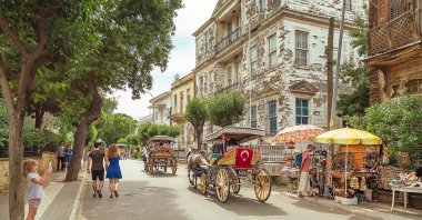 People move around the Princes' Island in horse-drawn carriages, Istanbul, Türkiye, June 30, 2018. (Shutterstock Photo)