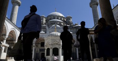 People walk in the courtyard of Eminönü Mosque on a sunny day in Istanbul, Türkiye, July 29, 2023. (EPA Photo)