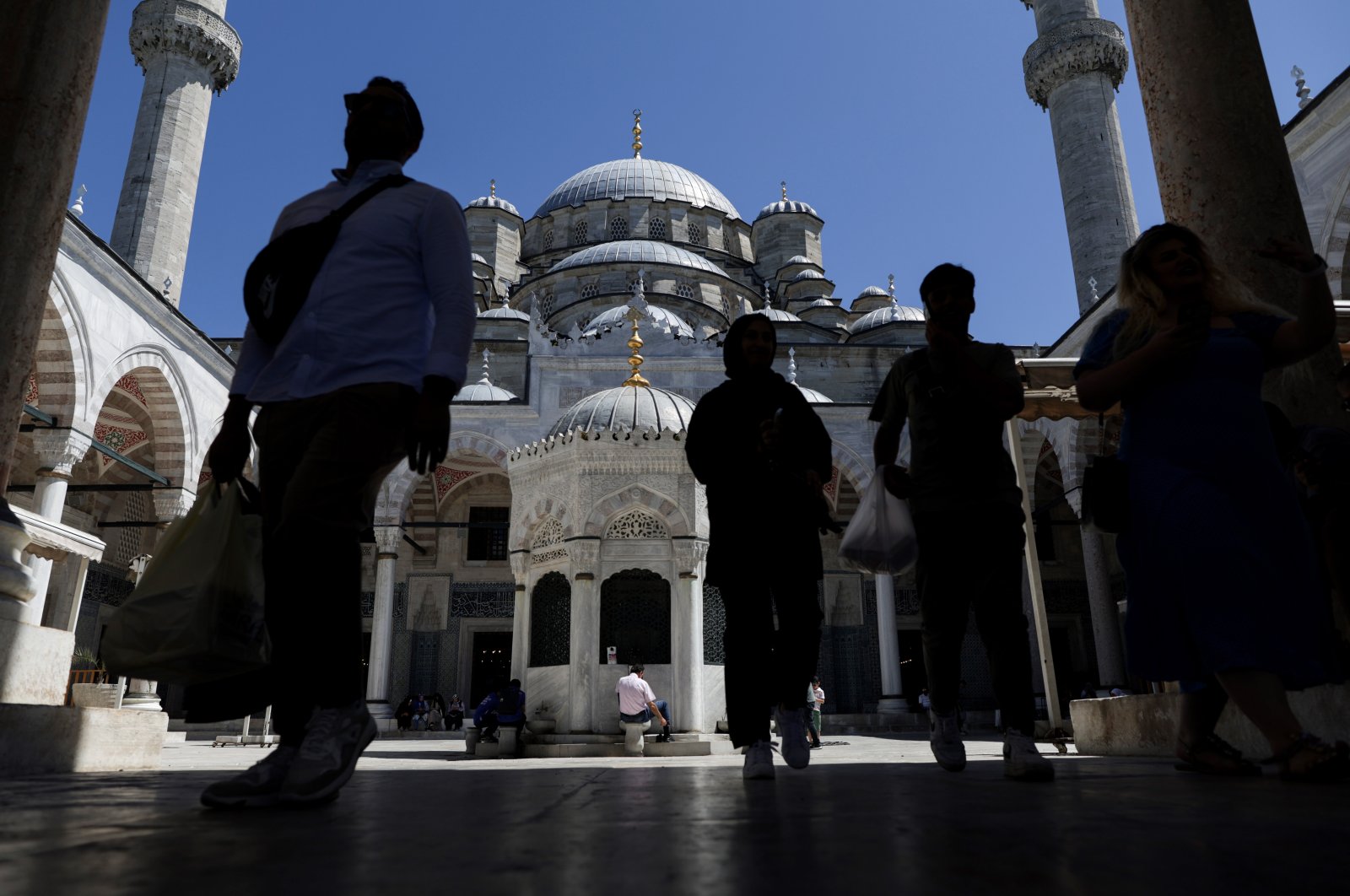 People walk in the courtyard of Eminönü Mosque on a sunny day in Istanbul, Türkiye, July 29, 2023. (EPA Photo)