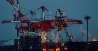 A cargo ship and containers are seen at an industrial port in Tokyo, Japan, Feb. 15, 2022. (Reuters Photo)