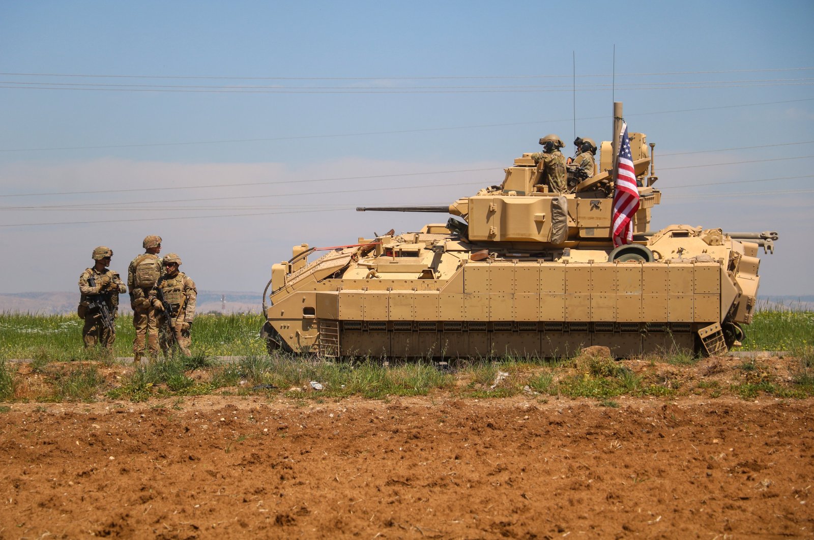 U.S. soldiers escort an armored tank part of a convoy carrying reinforcements for U.S. forces in regions controlled by terrorist group PKK/YPG in Deir ez-Zor, northern Syria, Aug. 15, 2023. (AA Photo)