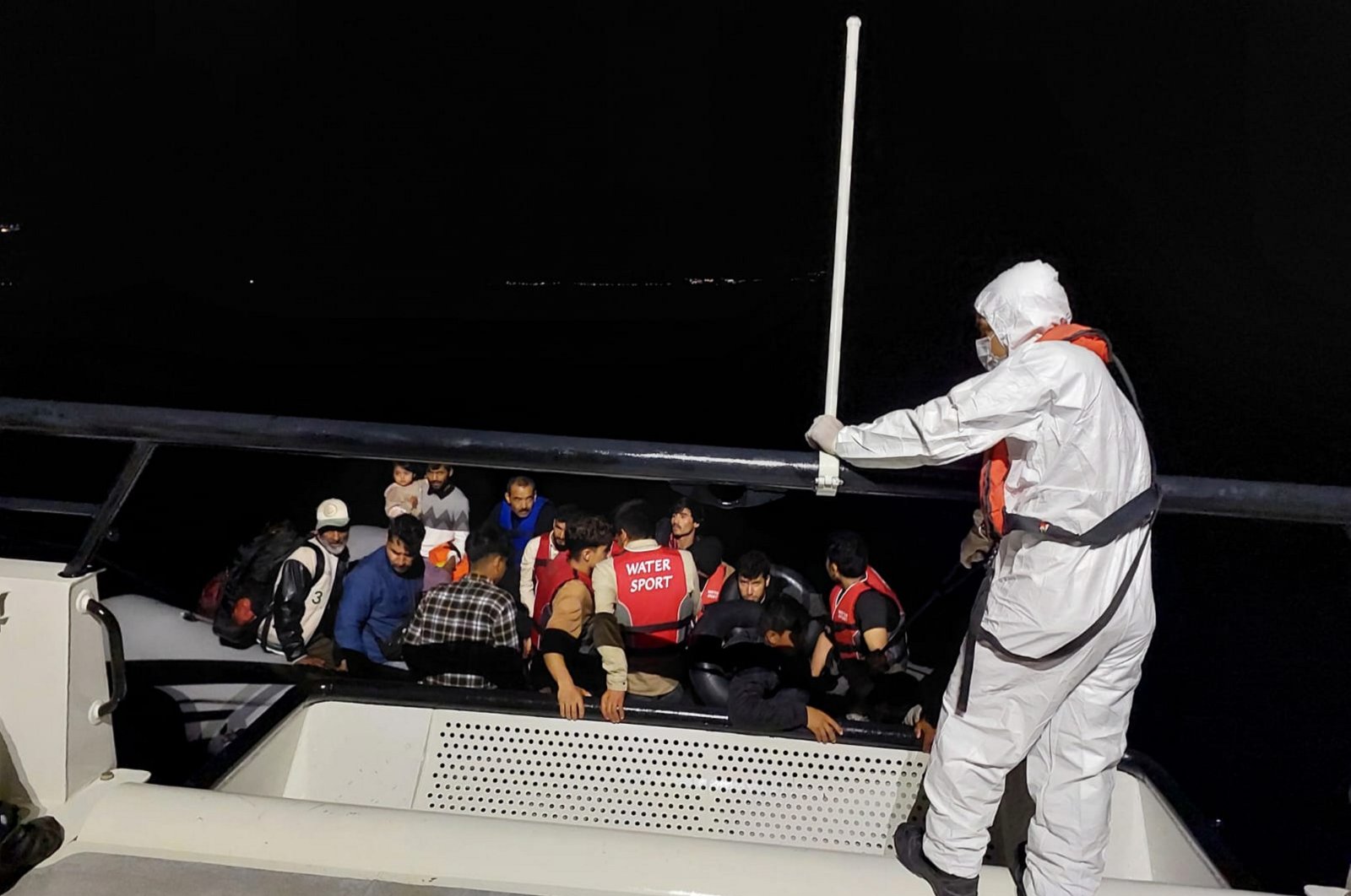 The coast guard assists rescued migrants, in Ayvacık, Çanakkale, northwestern Türkiye, Aug. 14, 2023. (AA Photo)