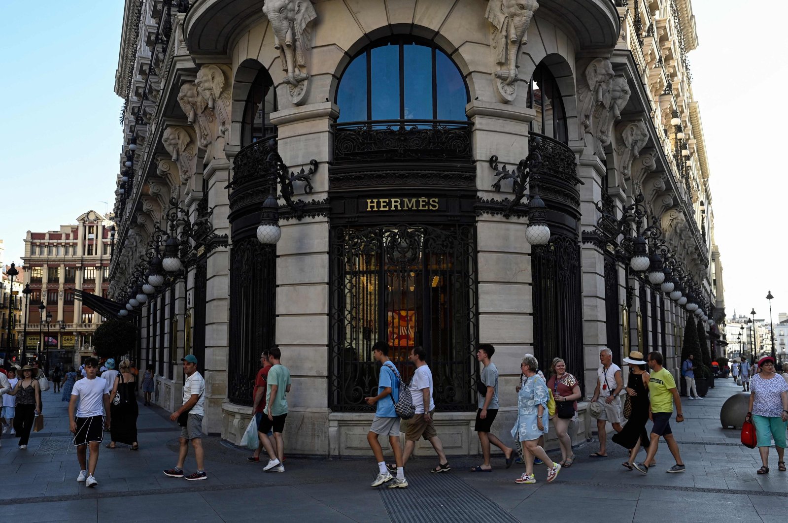 Tourists walk past a luxury store on Canalejas Square in Madrid, Spain, Aug. 10, 2023. (AFP Photo)