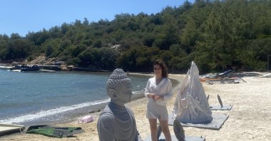 The artist Ceysu Uçan poses with her artwork in her "Cocoon" exhibition, Bodrum, Muğla, Türkiye. (Photo courtesy of the artist)
