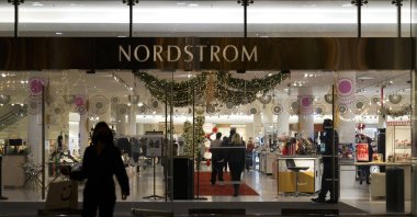 A security guard (R) stands at the entrance to a Nordstrom department store where a recent smash-and-grab robbery took place at the Grove Mall in Los Angeles, U.S., Dec. 2, 2021. (AP File Photo)
