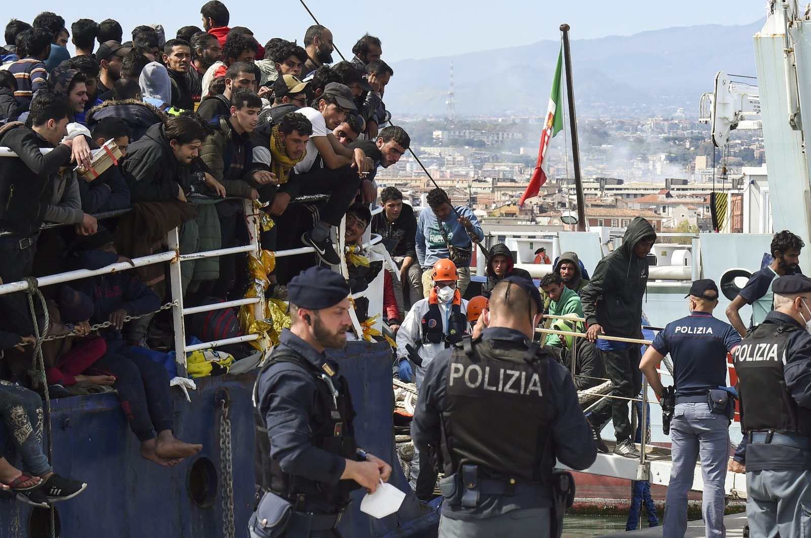 Migrants disembark from a ship in the Sicilian port of Catania, Italy, April 12, 2023. (AP File Photo)