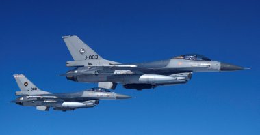 Netherlands' Air Force F-16 fighter jets fly alongside an aircraft simulating aerial interceptions during a media day illustrating how NATO Air Policing safeguards the Allies' airspace in the northern and northeastern region of the alliance, July 4, 2023. (Reuters Photo)