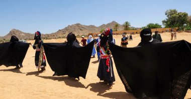 Men perform a traditional dance during the Sebeiba Festival, a yearly celebration of Tuareg culture, in the oasis town of Djanet in southeastern Algeria, July 29, 2023. (AFP Photo)