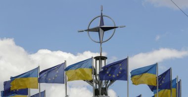 Ukraine's national flags and EU flags fly under the NATO logo in European Square amid the Russian invasion, downton Kyiv, Ukraine, July 12, 2023. (EPA Photo)