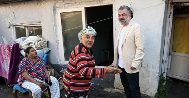 Head of Social Innovation at the Movement for Humanity and Civilization (IMH), Ercan Mayaer (R), chats with local Romani citizens during an interview with Anadolu Agency (AA) in Istanbul, Türkiye, Aug. 18, 2023. (AA Photo)