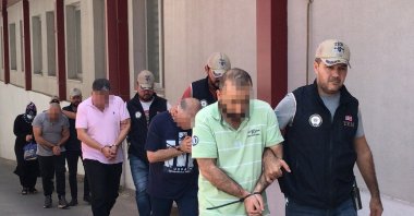 Police escort PKK suspects captured in operations, in Adana, southern Türkiye, Aug. 18, 2023. (İHA Photo)