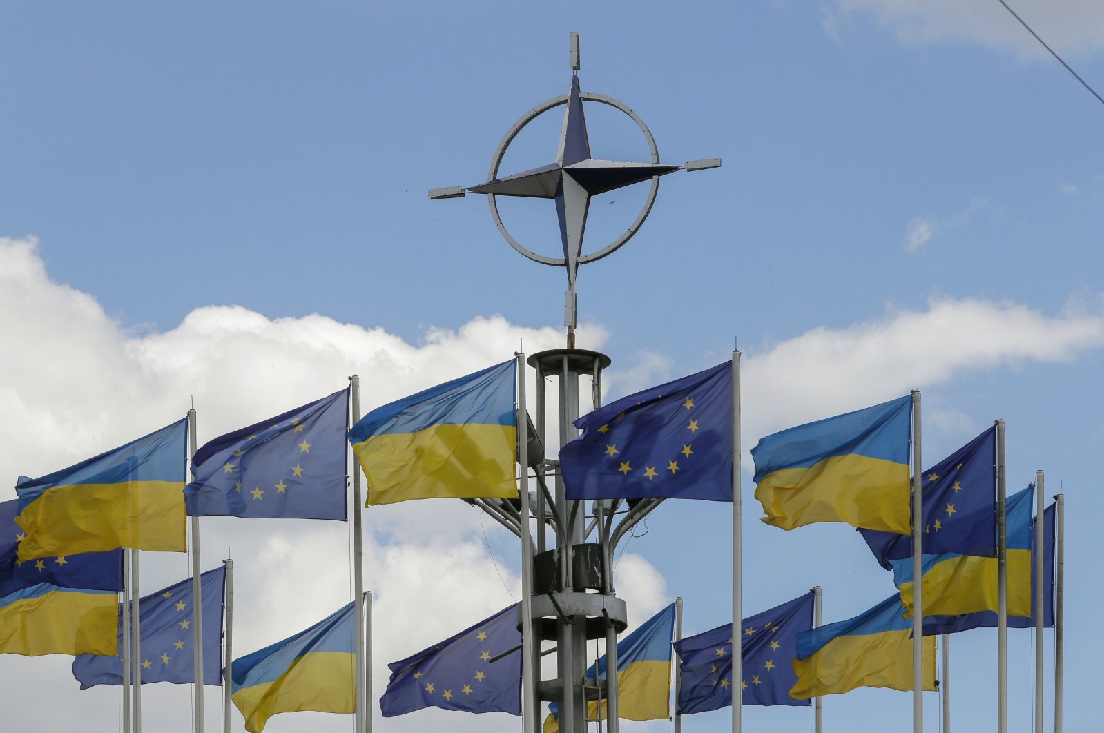 Ukraine&#039;s national flags and EU flags fly under the NATO logo in European Square amid the Russian invasion, downton Kyiv, Ukraine, July 12, 2023. (EPA Photo)