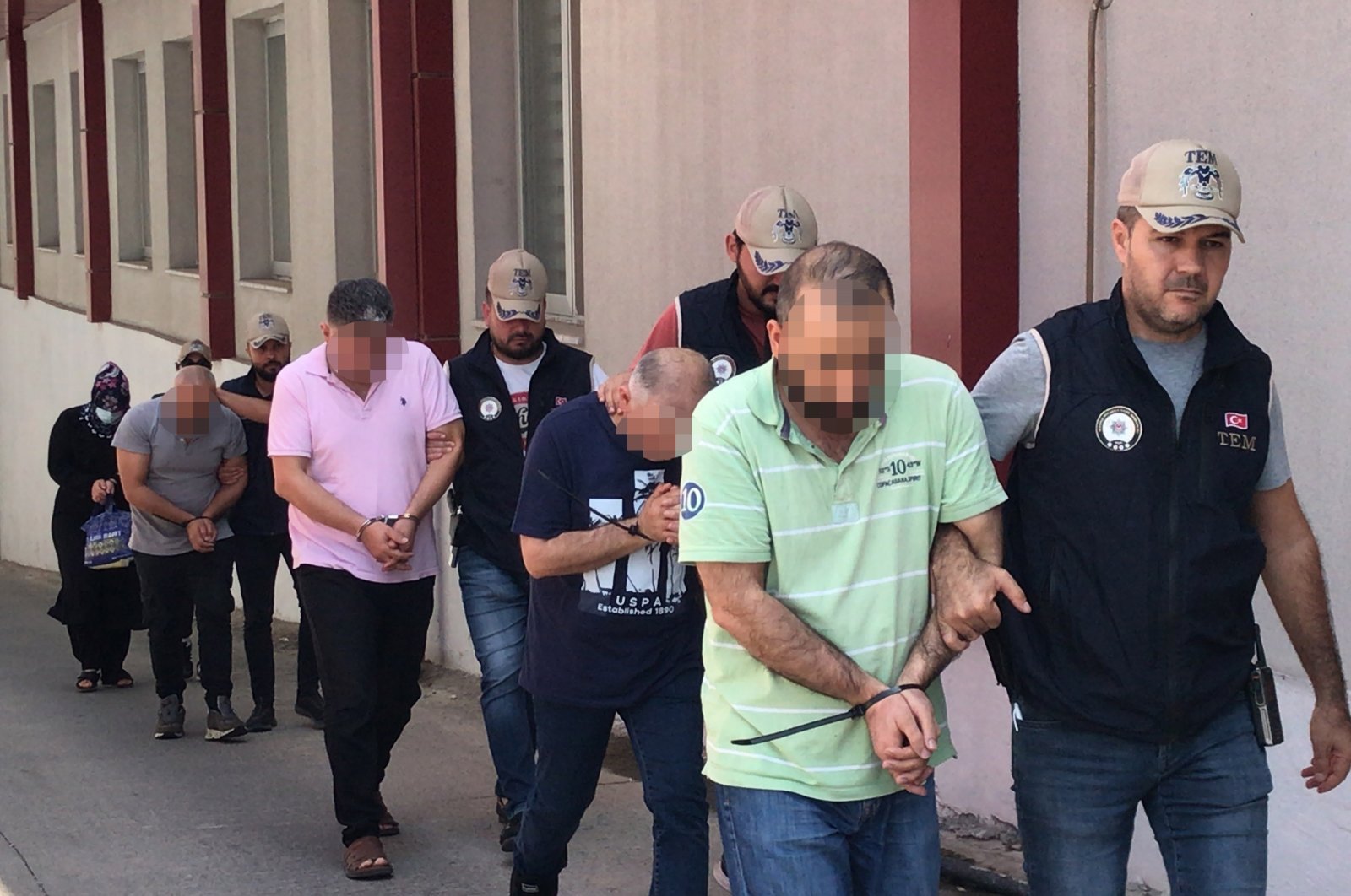 Police escort PKK suspects captured in operations, in Adana, southern Türkiye, Aug. 18, 2023. (İHA Photo)